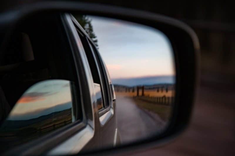Image of a rear-view mirror that evokes a moment of reflection on what we have lived or experienced in an iteration or period.