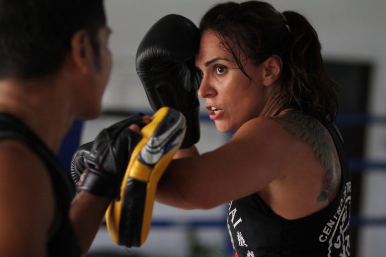 An image of a boxing training session between two athletes.