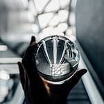 person holding clear glass decor